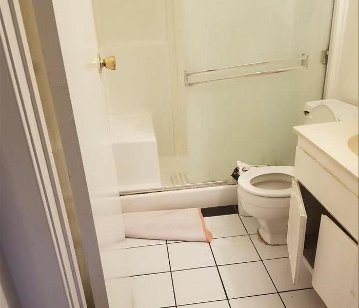 Photo is showing a bathroom that was affected by water damage from a roof leak