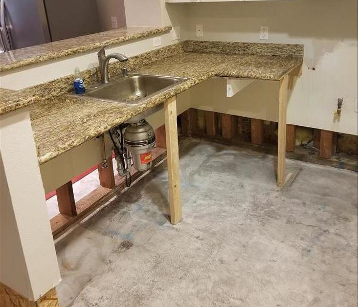 Photo is showing a countertop being held up in place by wood 2 x 4's